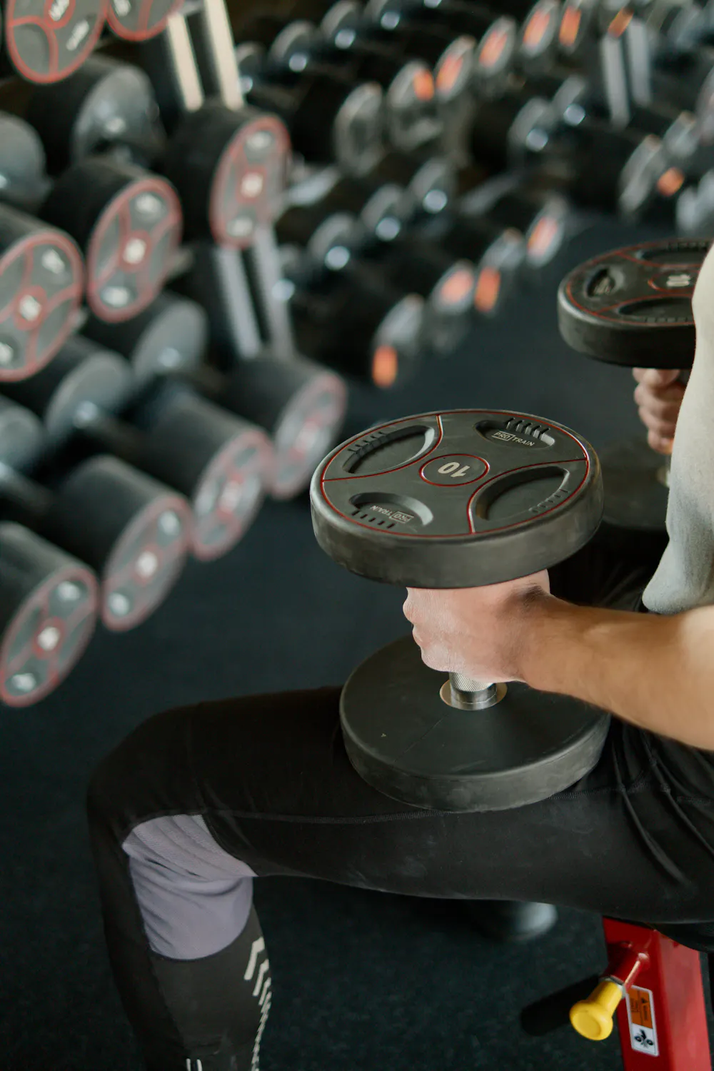 Personal trainer coaching a client with a tablet showing workout data
