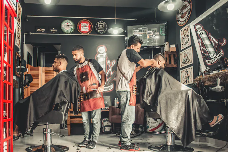 Barber giving precision haircut to client